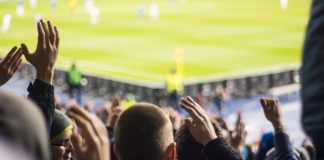 MPs debate: Could football “do without” gambling? Fans clapping their hands at a football stadium.