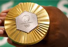 Olympics gets new leader as Kirsty Coventry takes gold in vote Gold medal of Paris 2024 Olympic Games handheld detail shot, sports competition winner symbol.