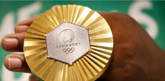 Olympics gets new leader as Kirsty Coventry takes gold in vote Gold medal of Paris 2024 Olympic Games handheld detail shot, sports competition winner symbol.