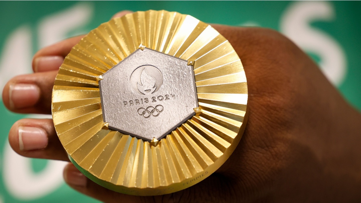 Gold medal of Paris 2024 Olympic Games handheld detail shot, sports competition winner symbol.