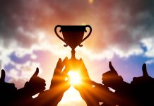 Women In Football eyes winning team with four new voices Success of teamwork. Winning team with trophy in hands.