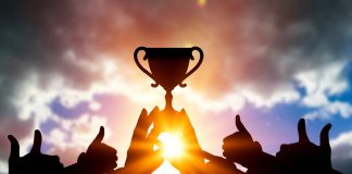 Women In Football eyes winning team with four new voices Success of teamwork. Winning team with trophy in hands.