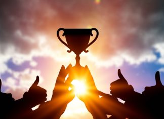 Women In Football eyes winning team with four new voices Success of teamwork. Winning team with trophy in hands.