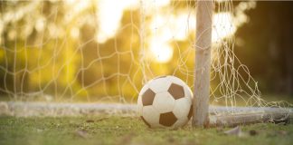 Brazil’s CBF and Sportradar tighten the net on match manipulation Football in front of a net at sunset.