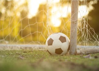 Brazil’s CBF and Sportradar tighten the net on match manipulation Football in front of a net at sunset.