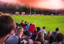 Easter crowds crack records as Super League hits new highs Soccer or rugby supporters in the stadium during match.