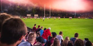 Easter crowds crack records as Super League hits new highs Soccer or rugby supporters in the stadium during match.