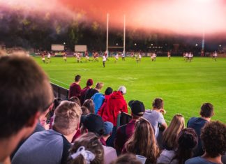 Easter crowds crack records as Super League hits new highs Soccer or rugby supporters in the stadium during match.