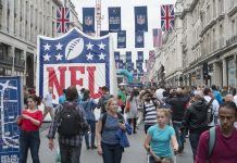 Three NFL franchises look to grow fandoms beyond US with UK marketing rights LONDON UK - SEPTEMBER 27: Crowded Regent street with NFL inflatable banners and flags hanging above. September 27 2014 in London. The street was closed to traffic to host NFL related games and events.