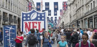 Three NFL franchises look to grow fandoms beyond US with UK marketing rights LONDON UK - SEPTEMBER 27: Crowded Regent street with NFL inflatable banners and flags hanging above. September 27 2014 in London. The street was closed to traffic to host NFL related games and events.