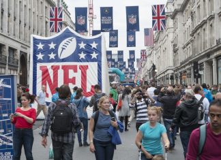 Three NFL franchises look to grow fandoms beyond US with UK marketing rights LONDON UK - SEPTEMBER 27: Crowded Regent street with NFL inflatable banners and flags hanging above. September 27 2014 in London. The street was closed to traffic to host NFL related games and events.