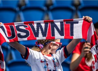‘They didn’t try to win’: Fan sues USWNT for $100m PARIS, FRANCE - 16 JUNE, 2019: A fan holds USWNT scarf before the 2019 FIFA Women's World Cup match between USA and Chile.