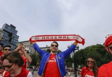 Arsenal is taking lessons from Amazon not Manchester United NEW YORK CITY - AUGUST 16 2014: Arsenal NYC Football Club supporters held a rally & photo shoot to celebrate their team's winning season in Union Square Park.