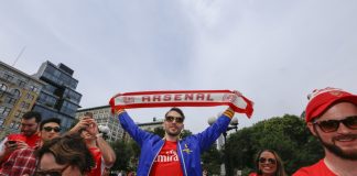 Arsenal is taking lessons from Amazon not Manchester United NEW YORK CITY - AUGUST 16 2014: Arsenal NYC Football Club supporters held a rally & photo shoot to celebrate their team's winning season in Union Square Park.