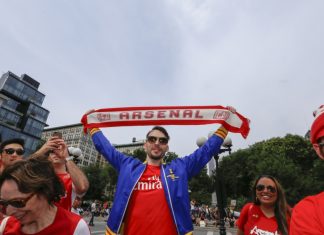 Arsenal is taking lessons from Amazon not Manchester United NEW YORK CITY - AUGUST 16 2014: Arsenal NYC Football Club supporters held a rally & photo shoot to celebrate their team's winning season in Union Square Park.