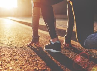 Enhanced Games founder open to debate “anytime, anywhere” Athlete woman in running start pose on the city street. Sport tight clothes. Bright sunset, blurry background. Horizontal