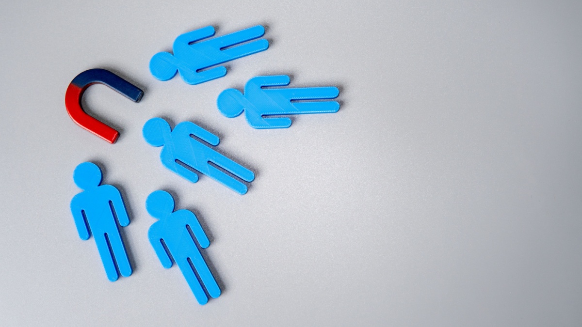 A magnet pulling blue male icons towards it, representing CAA's recent purchase of Portas