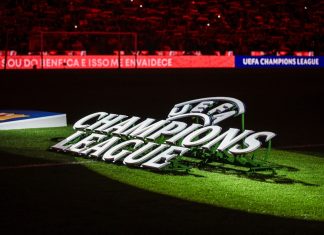 Football reigns as king of crypto investment, but for how long? UEFA Champions League logo on pitch.