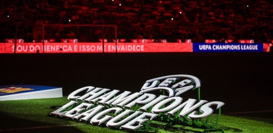 UEFA Champions League logo on pitch.