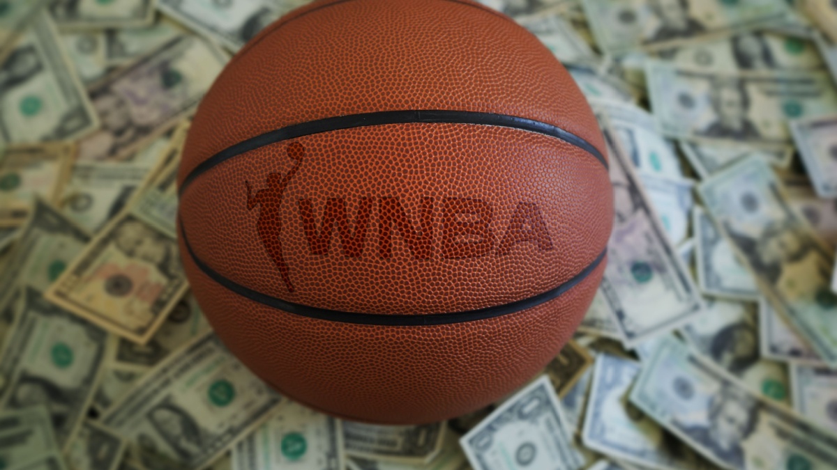 An WNBA basketball on a pile of US dollars. Follows the announcement of BetMGM investing in the sport.