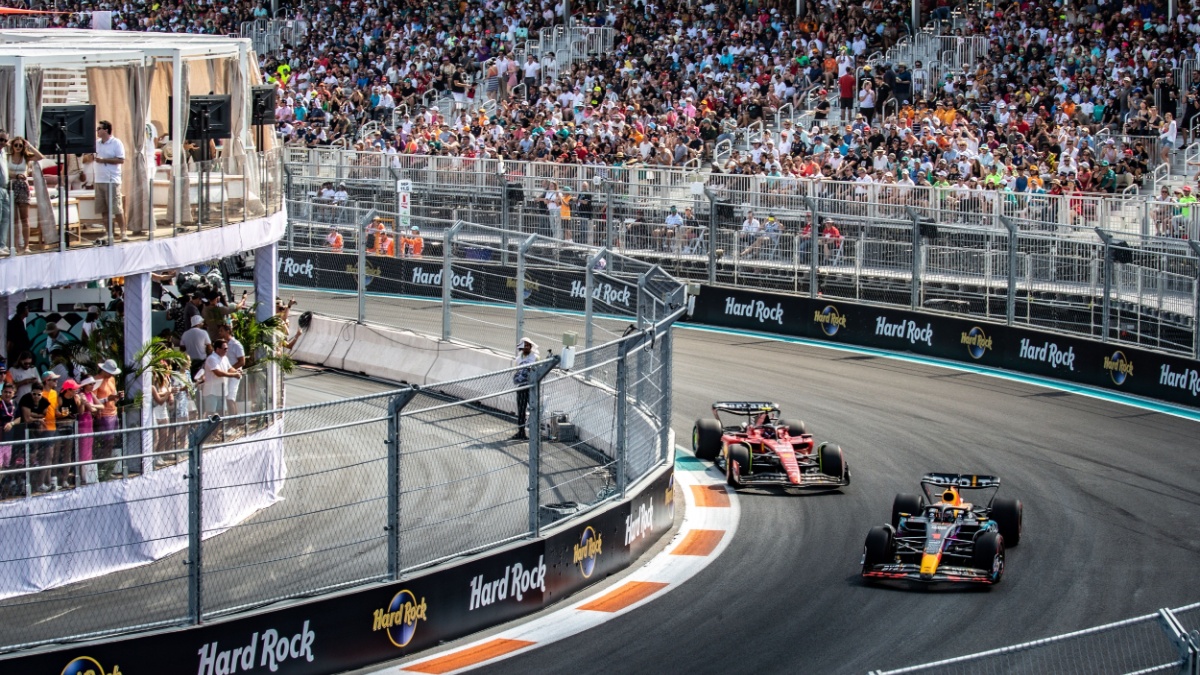 Two formula 1 cars racing during the 2023 Miami Grand Prix, two years before PwC and F1's partnership highlighted the importance of sports consulting