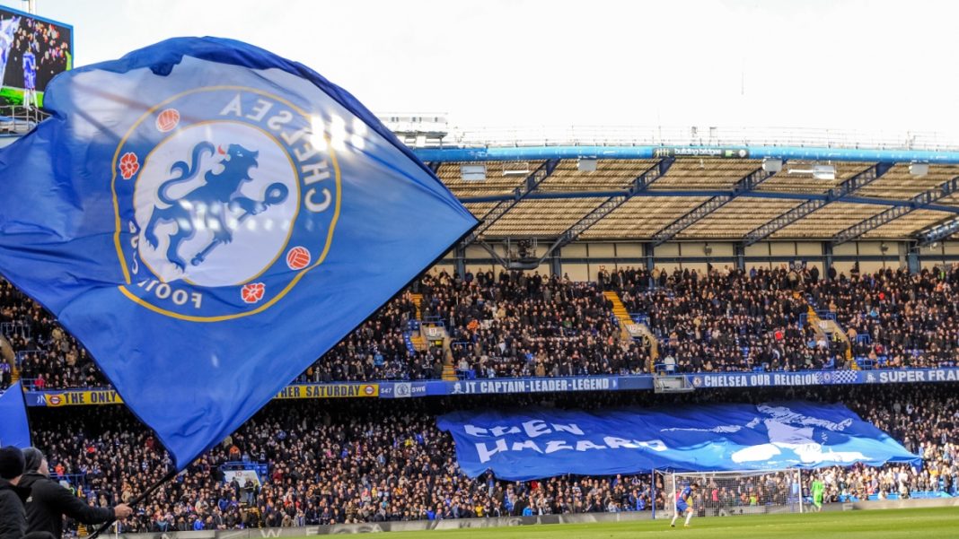 Chelsea-(2) London, UK - March 10 2019: the view of Stamford bridge with big Chelsea flag during the match of Premier League between Chelsea - Wolverhampton Wanderers, Stamford Bridge stadium.