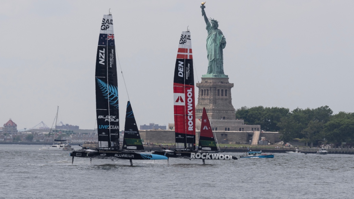 New Zealand and Denmark teams battle during 3rd race during SailGP second day in New York harbor with Statue of Liberty in the background on June 23, 2024.