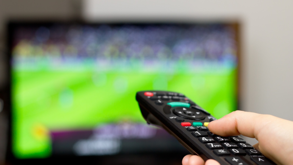 Watching soccer game on TV.