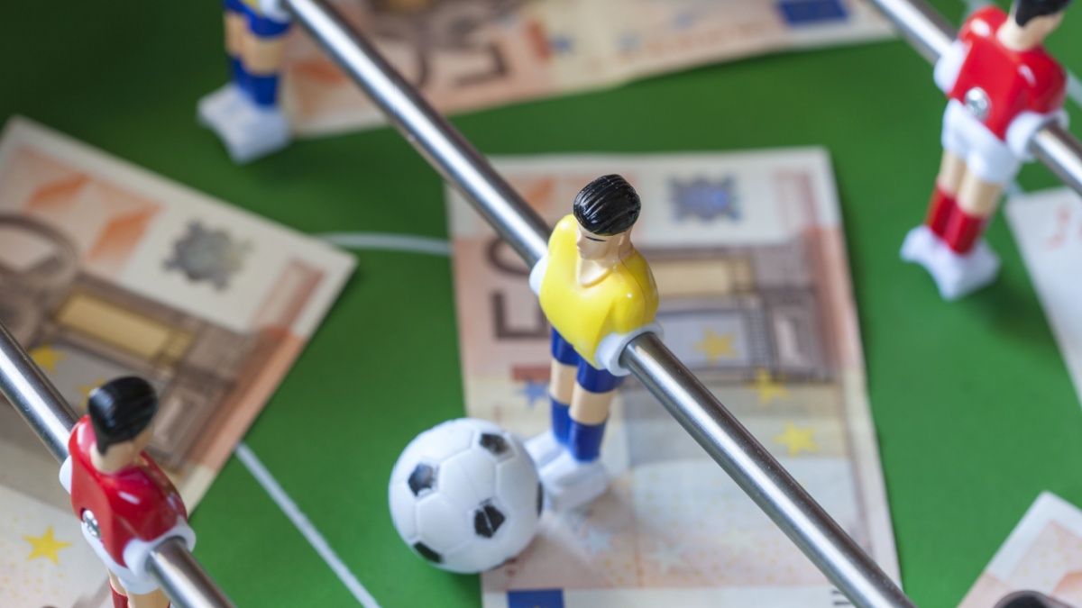 Football table with money on the top representing match-fixing