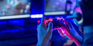 Can AI help fans reclaim control of live sport? A person holding a controller, demonstrating how AI can help control live sport fan engagement