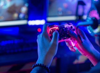 Can AI help fans reclaim control of live sport? A person holding a controller, demonstrating how AI can help control live sport fan engagement