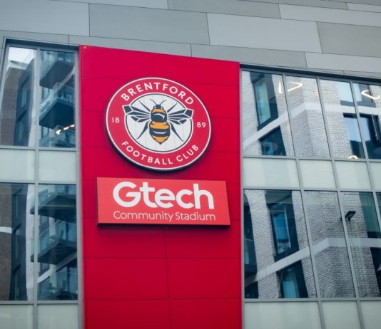 Brentford extends Hollywoodbets deal despite front-of-shirt ban LONDON- JULY 31, 2023: Brentford FC football stadium exterior logo in West London.