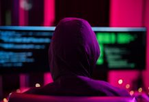 LaLiga blasts pirate streams as cybercrime gateways Black Hat Hacker hoodie concept at a laptop computer hacking the Internet. Cyber crime and security principles.