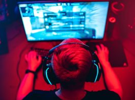 The rise and fall of Guild Esports Professional e-sport studio room with personal computer armchair, keyboard for stream in neon color blur background. Soft focus.