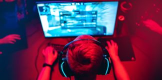 The rise and fall of Guild Esports Professional e-sport studio room with personal computer armchair, keyboard for stream in neon color blur background. Soft focus.