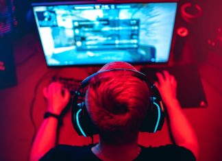 The rise and fall of Guild Esports Professional e-sport studio room with personal computer armchair, keyboard for stream in neon color blur background. Soft focus.