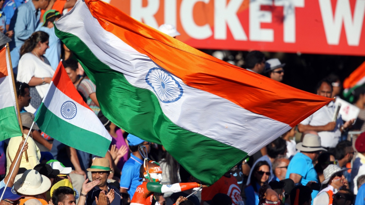 India fans wave their national flags during the Pool B Cricket World Cup match between India and Ireland at Sedden Park in Hamilton on March 10, 2015. AFP PHOTO / Michael Bradley.