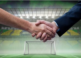 Should the WSL embrace joint deals like La Liga? Composition of businessmen shaking hands over sports stadium. sports, deal, agreement and competition concept digitally generated image.