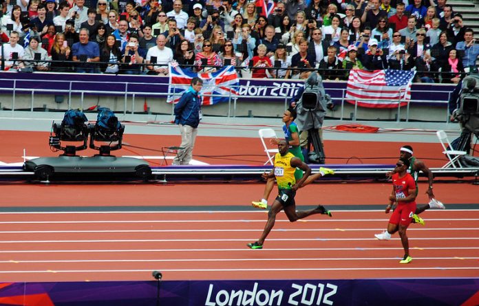 8161675346_58a56766e2_c Usain Bolt leads easily out of the bend in the mens 200m at the London Olympics. Image credit: Mark Wordy