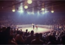 Has Zuffa Boxing and Netflix proven a new model can work? Blurred background of a captivating view of an iconic boxing arena featuring a spotlight on the ring, surrounded by a large audience, capturing the excitement and energy of the event.
