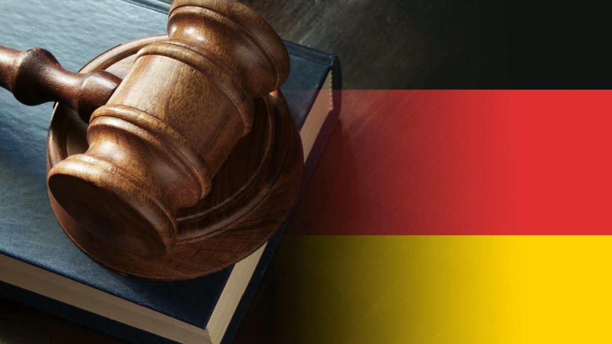 Gavel and legal book on wooden table, collage with german flag.