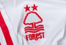 Nottingham Forest turns sponsor ban into marketing opportunity Kyiv, Ukraine, May 30, 2025. Close-up of a white Nottingham Forest football jersey with embroidered club logo and stars.