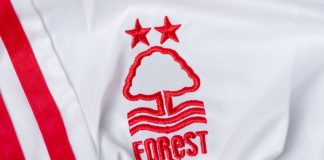Nottingham Forest turns sponsor ban into marketing opportunity Kyiv, Ukraine, May 30, 2025. Close-up of a white Nottingham Forest football jersey with embroidered club logo and stars.