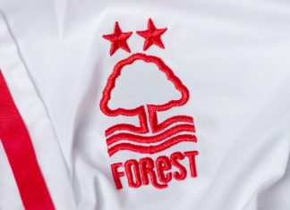 Nottingham Forest turns sponsor ban into marketing opportunity Kyiv, Ukraine, May 30, 2025. Close-up of a white Nottingham Forest football jersey with embroidered club logo and stars.