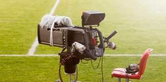 Northern Premier League streaming dispute explained Television broadcast camera shooting at a sunny football game.