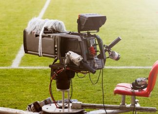 Northern Premier League streaming dispute explained Television broadcast camera shooting at a sunny football game.