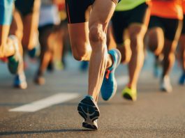 Garmin runs into legal trouble with Strava Close-Up of Marathon Runners' Legs on City Road During Athletic Competition.