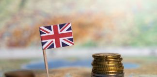 The athlete tax exodus: Why the UK is losing its biggest stars british flag with stacked coins on a world map, symbolizing the economy, financial system, and trade of the united kingdom