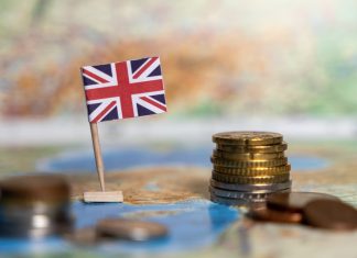 The athlete tax exodus: Why the UK is losing its biggest stars british flag with stacked coins on a world map, symbolizing the economy, financial system, and trade of the united kingdom