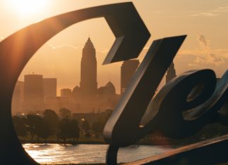 Cleveland Guardians’ Luis Ortiz charged in MLB betting scandal Cleveland skyline behind the Cleveland script sign at Sunrise, moody morning sunrise, midwest city, Browns, Guardians (MLB), City